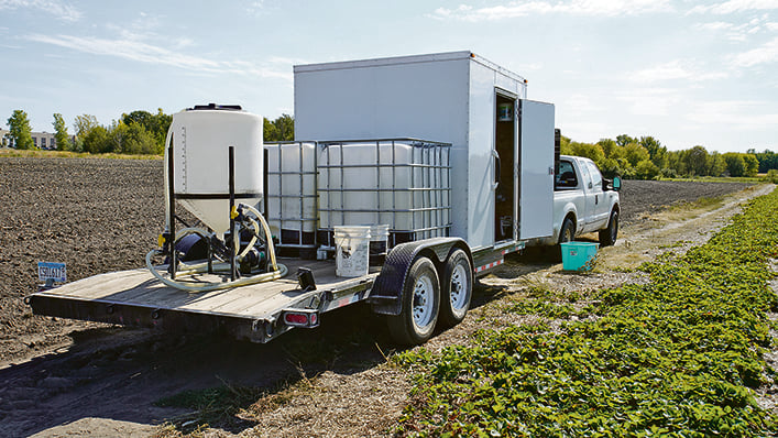 The basics of applying crop protection products with a small 30 litre tank isn’t all that different from a larger operation — a support trailer and handling equipment are still needed. Bouwman says the T30 returns to the trailer every eight minutes for a tank fill and fresh battery. | Maverick photo