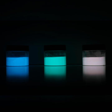 Three glow in the dark jars with glowing pigments