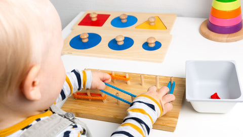 Toddler playing with montessori toys