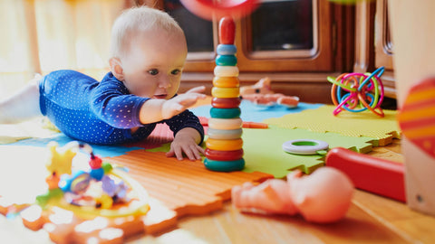 baby playing with wooden montessori toys
