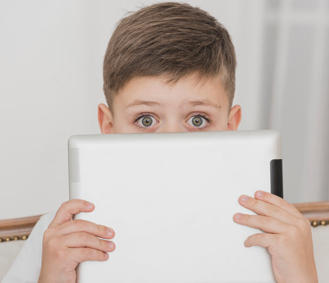little boy holding tablet screen close