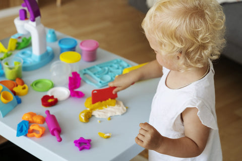 Child playing with playdough-montessori-toys