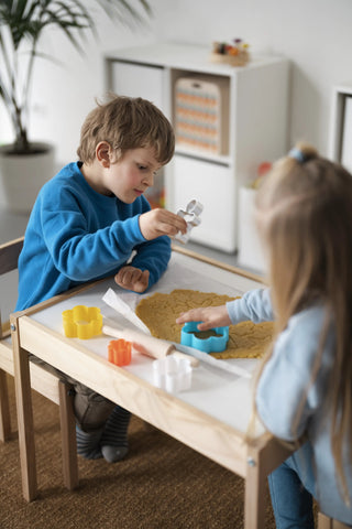 kids playing together at table. making cookies. practical montessori activities. In-door montessori activities