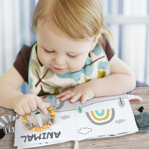 Baby-playing-with-montessori-sensory-book