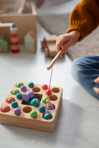 child-playing-with-fishing-toy-learning-colours