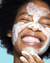 An image of a model applying the Super Knights Purifying Clay Mask to her face.