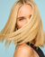 A stopframe of a blonde model turning her head to the viewer so that her hair still covers half of her face. Her hair looks fantastic after using Dr. Groot Professional Bonding System Bond Fortifying #1 Shampoo