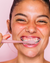 A model brushing her teeth with the Euthymol Whitening Toothbrush.