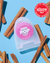 A container of Reach POP Floss Cinnamon on a light blue background lying among cinnamon sticks