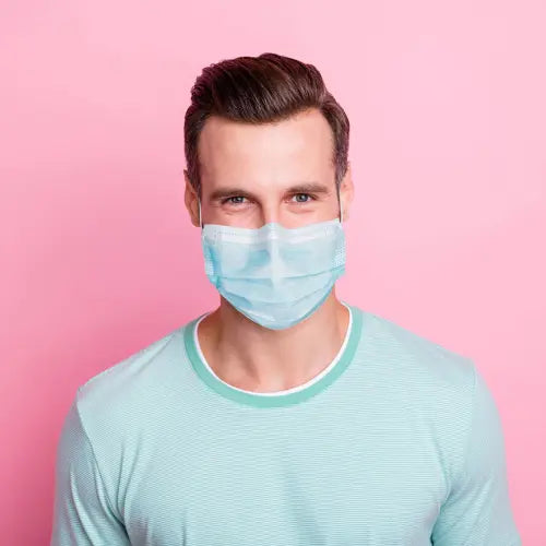 Man standing with surgical mask on face