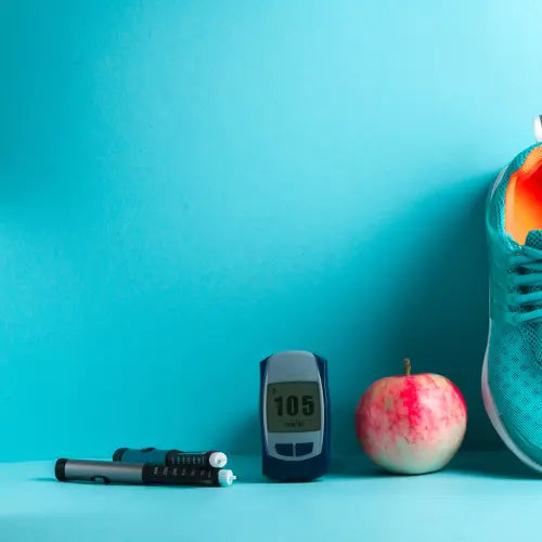 blood sugar level meter and insulin injector lay with an apple and a sports sneaker on a blue background