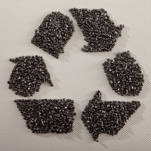 the recycle symbol, made of small pieces of acetate pellets.