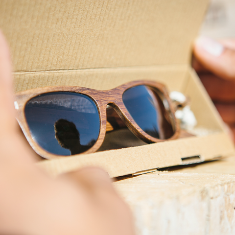 Wooden sunglasses in their packaging