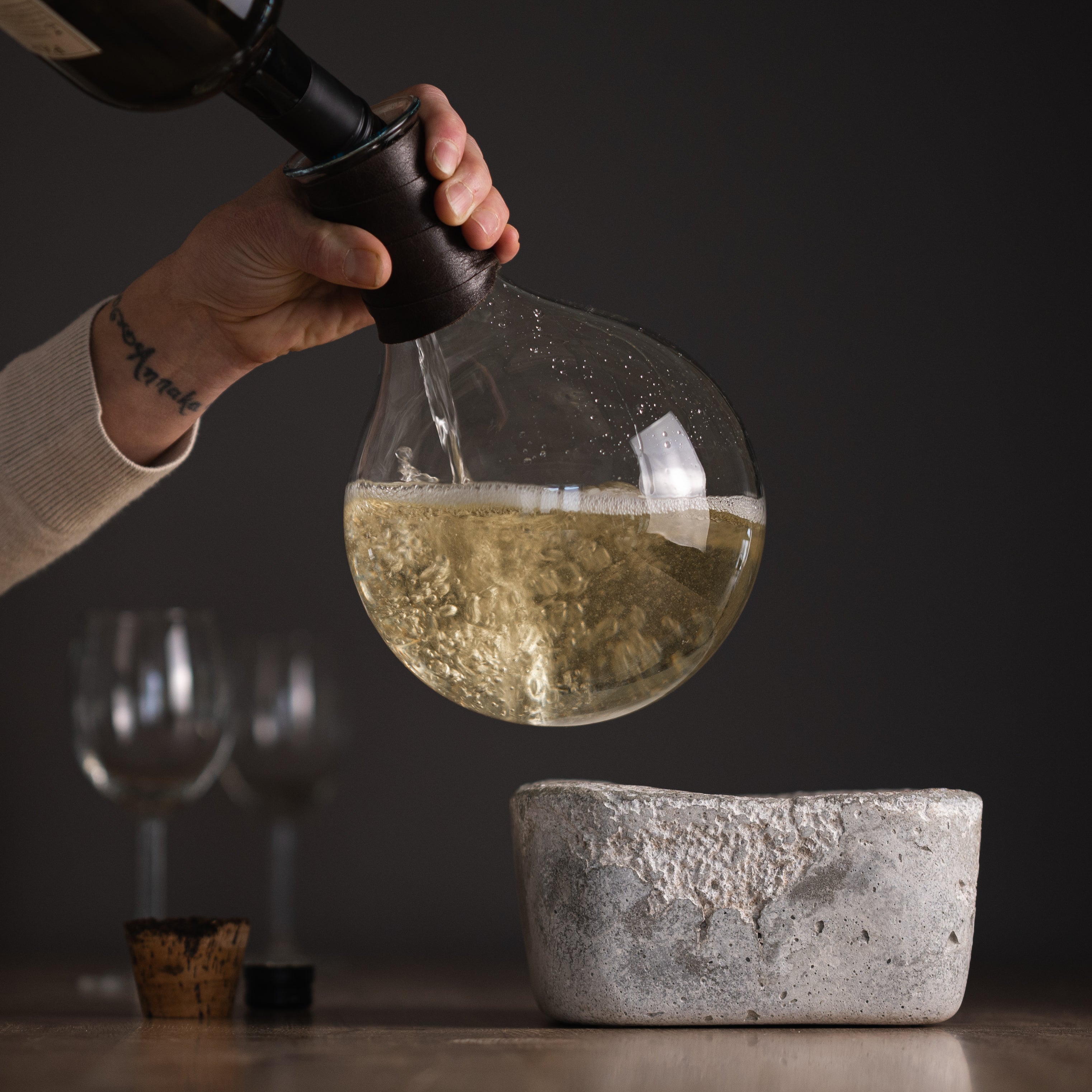 pouring white wine into Rock Bottom wine decanter with 2000ml flask by studio50