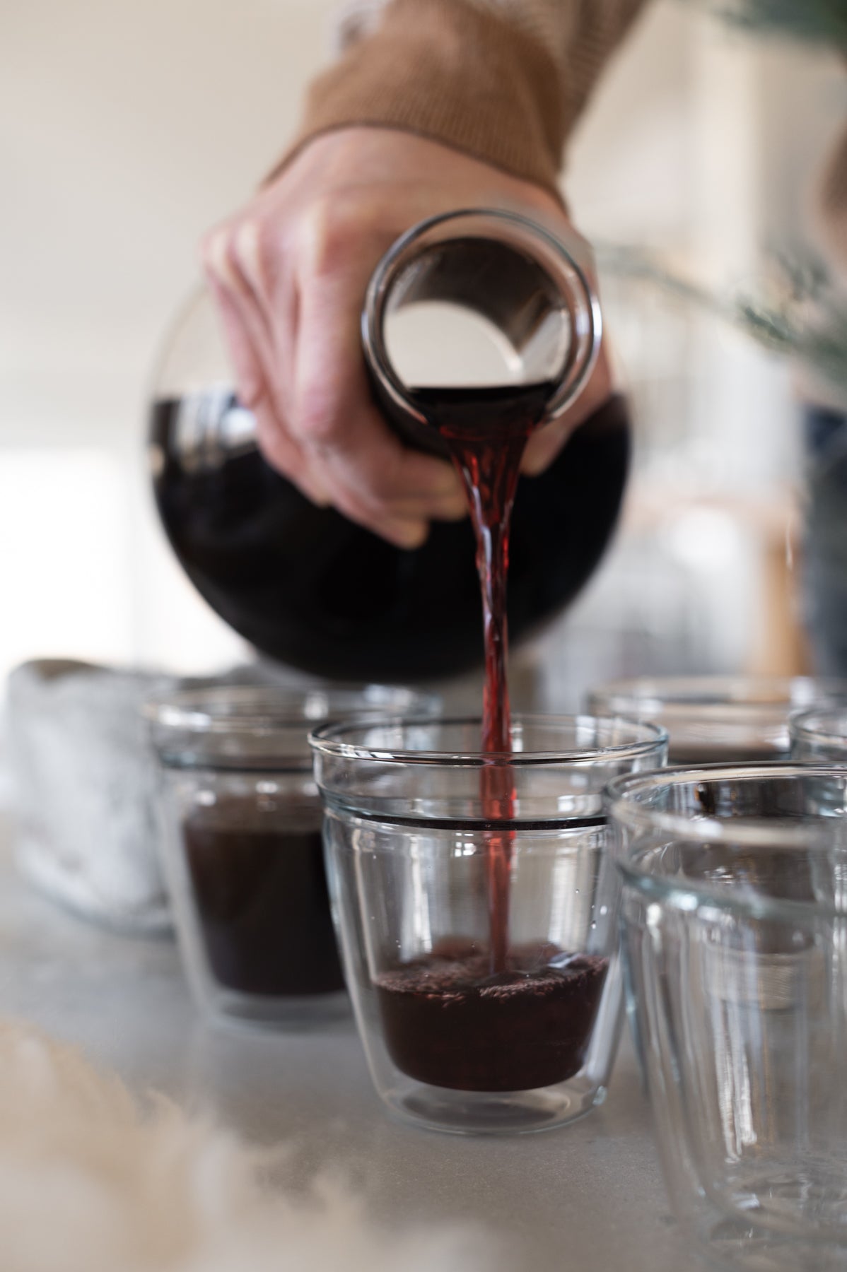 decanter pouring red wine sangria in a cup