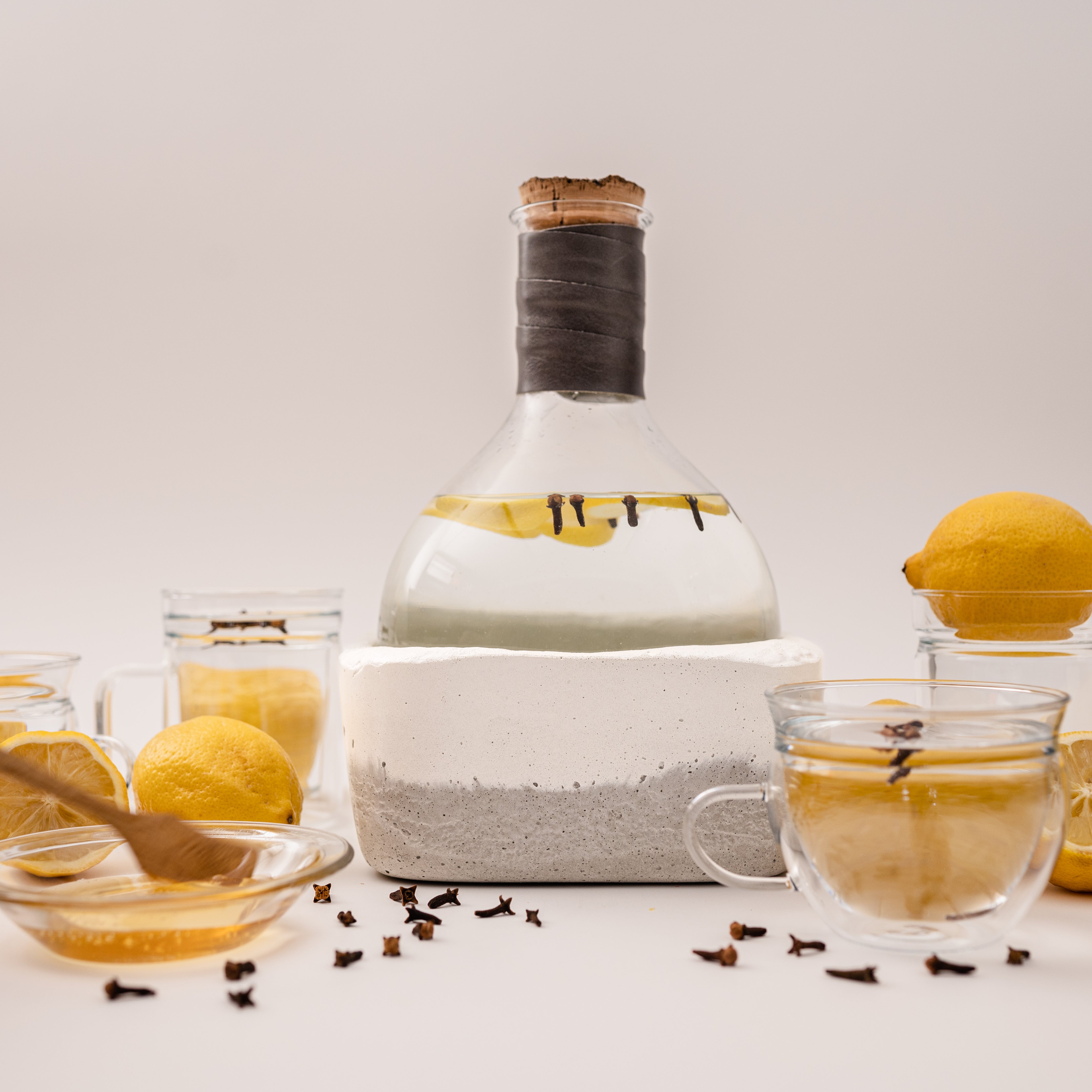 Rock Bottom Vessel concrete decanter with hot infused water of lemons, honey and cloves by studio50