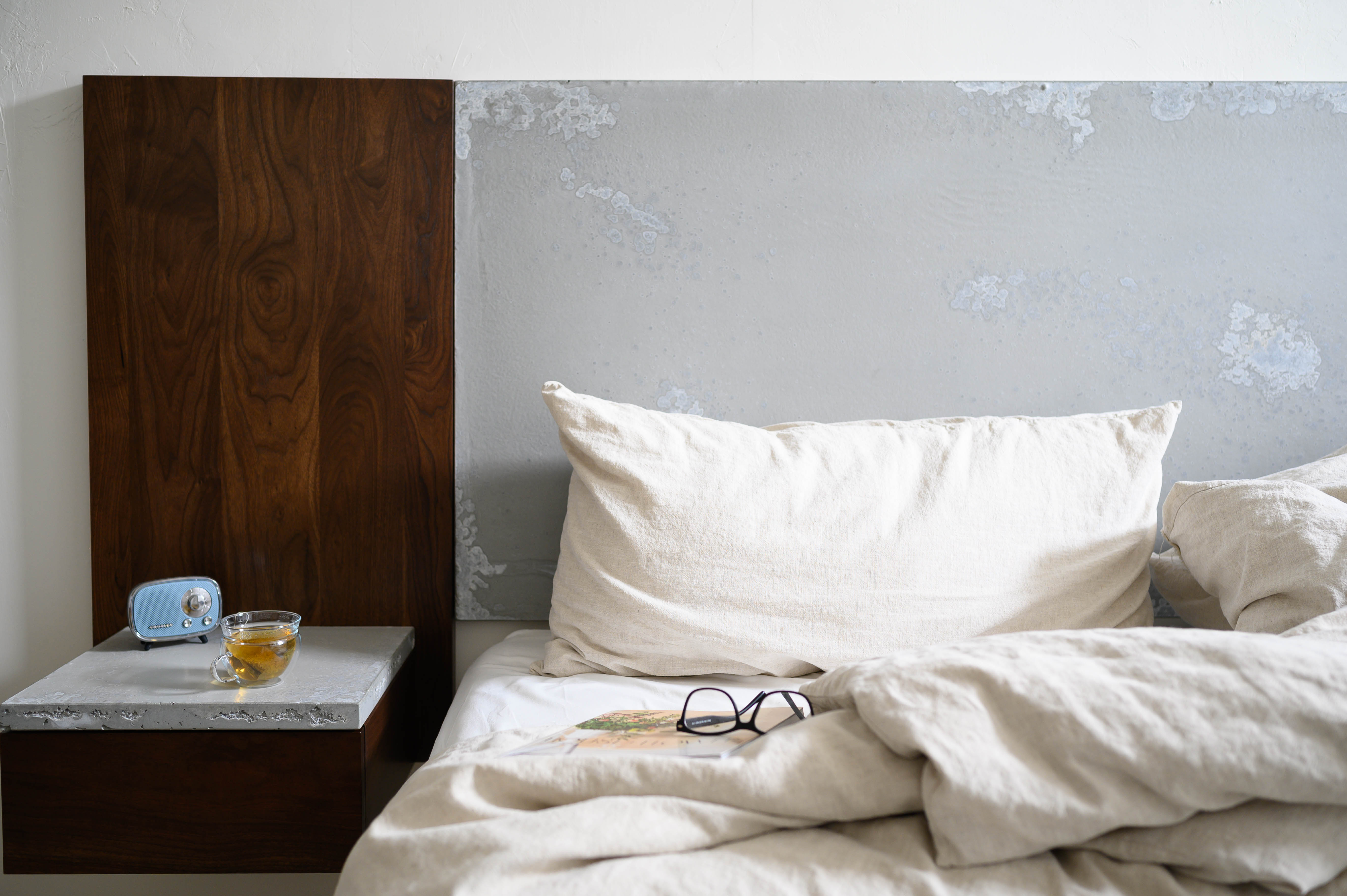 concrete headboard, linen pillows