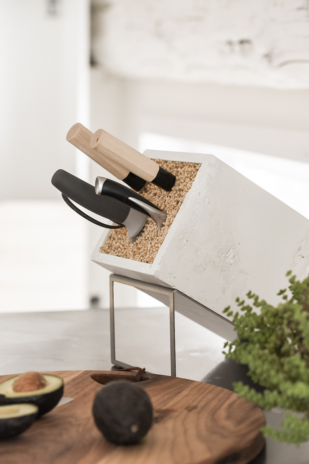 white textured concrete knife block tilted stainless steel stand