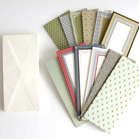 A collection of papers and envelopes on a white surface.