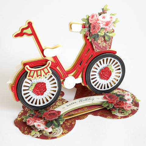 A pop up card with a bicycle and flowers.