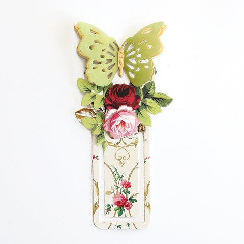 A bookmark with a butterfly and roses on it.