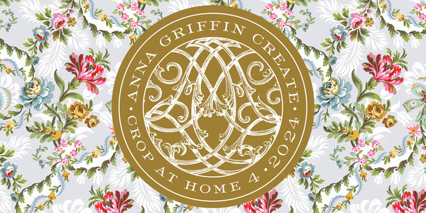 Logo for "anna griffin create" featuring ornate monogram inside a golden circle, set against a floral background in pastel tones.