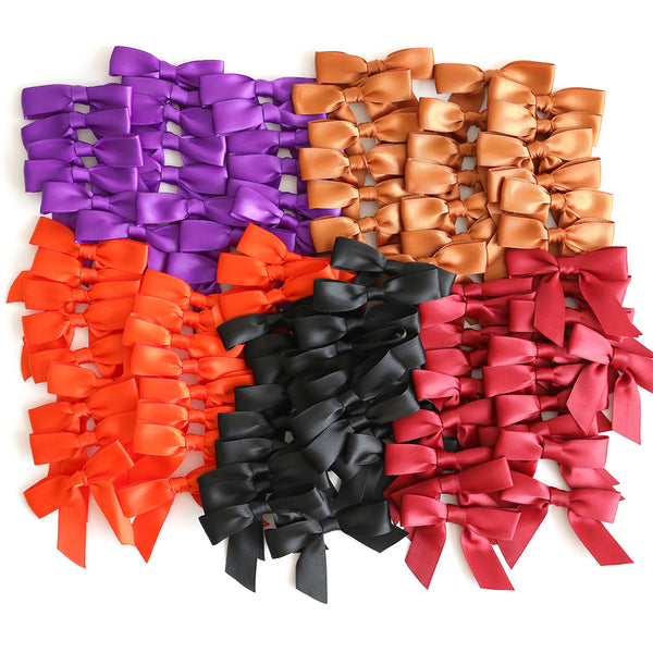 An arrangement of Falloween and Christmas Pre-Tied Bows in colorful fall hues of purple, orange, black, red, and gold, neatly organized in rows on a white background.