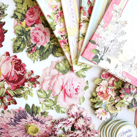 A collection of paper flowers and cards on a table.