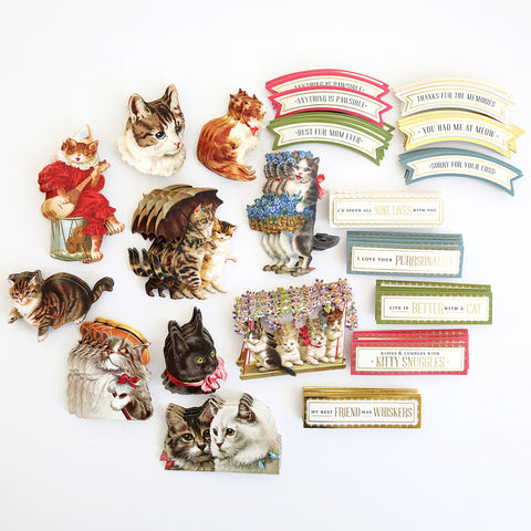 A collection of vintage cat magnets on a white surface.