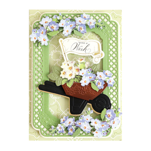 A card with a wheelbarrow and flowers.