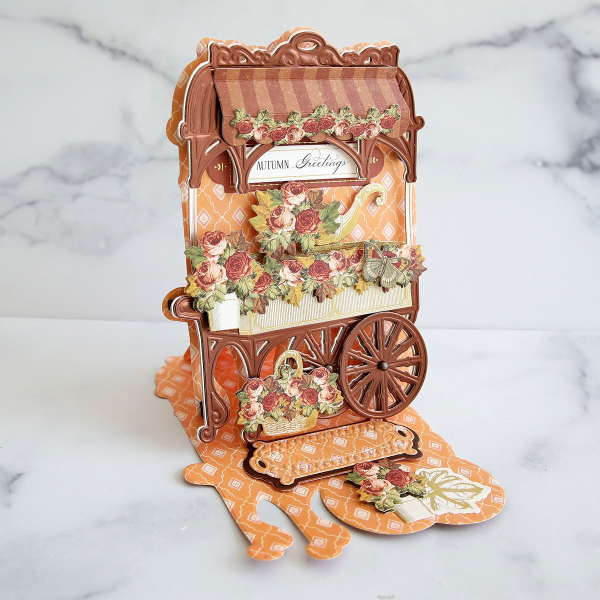 A pop up card with an orange cart and flowers.