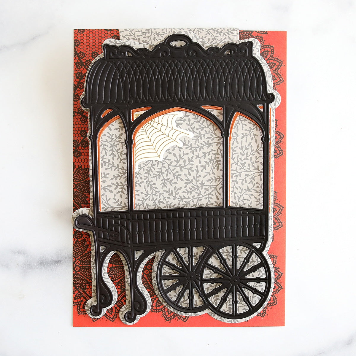 A black and white card with a carriage on it.