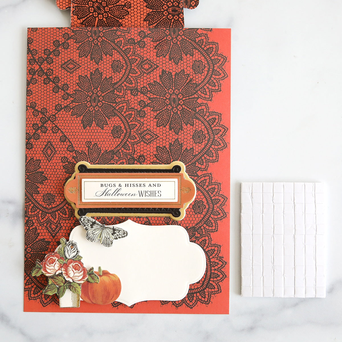 A card with lace and a pumpkin on it.