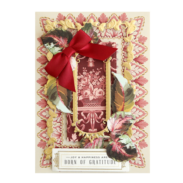 A red and pink card with a bow on it.