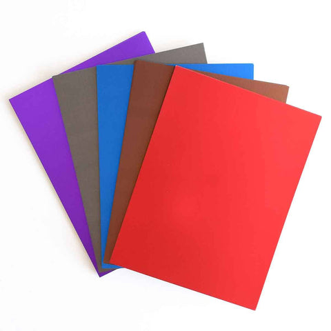 A set of colored paper on a white surface.