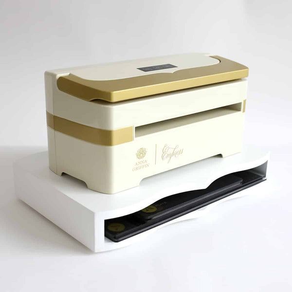 a white and gold box sitting on top of a white table.