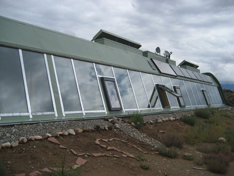 A solar system on the front face of an Earthship, Taos, New Mexico, USA – B. Trauth