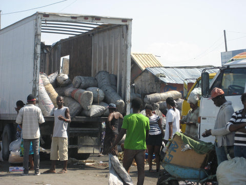 Charcoal being delivered to markets in Port Au Prince Haiti. This is harvested deep in the mountains and hauled by boat and truck to urban markets to fulfill cooking needs. Each bag costs $6US and will only last 30 days on average. – B. Trauth