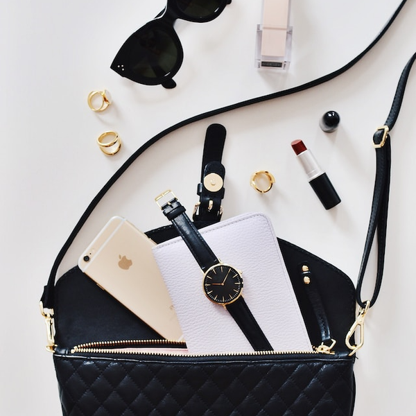 Luxury's Retail Rise - Luxury handbag with watch, phone, lipstick, rings