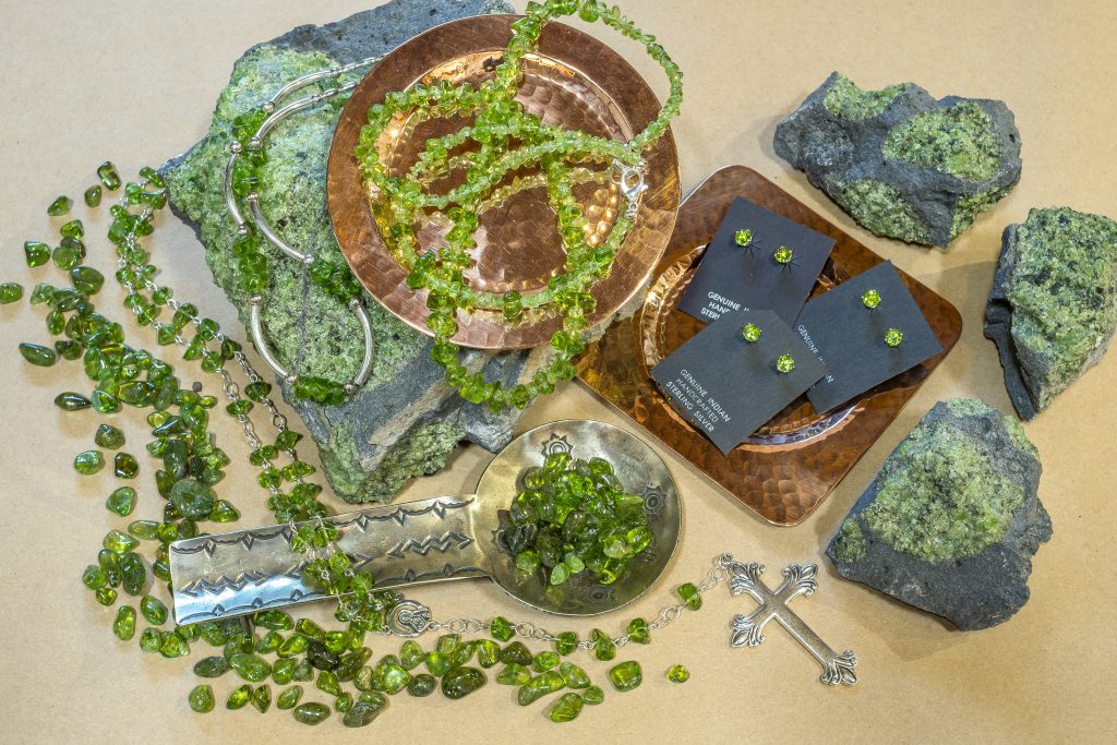 Peridot Jewelry found at the Pickle Barrel Trading Post arranged with raw and processed Peridot minerals and gems