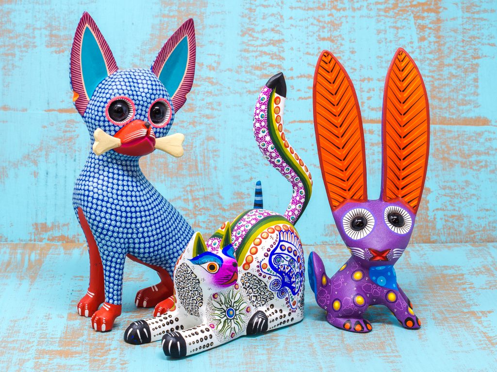 Mexican Oaxacan carved animals are known for their bright colors and amusing poses.