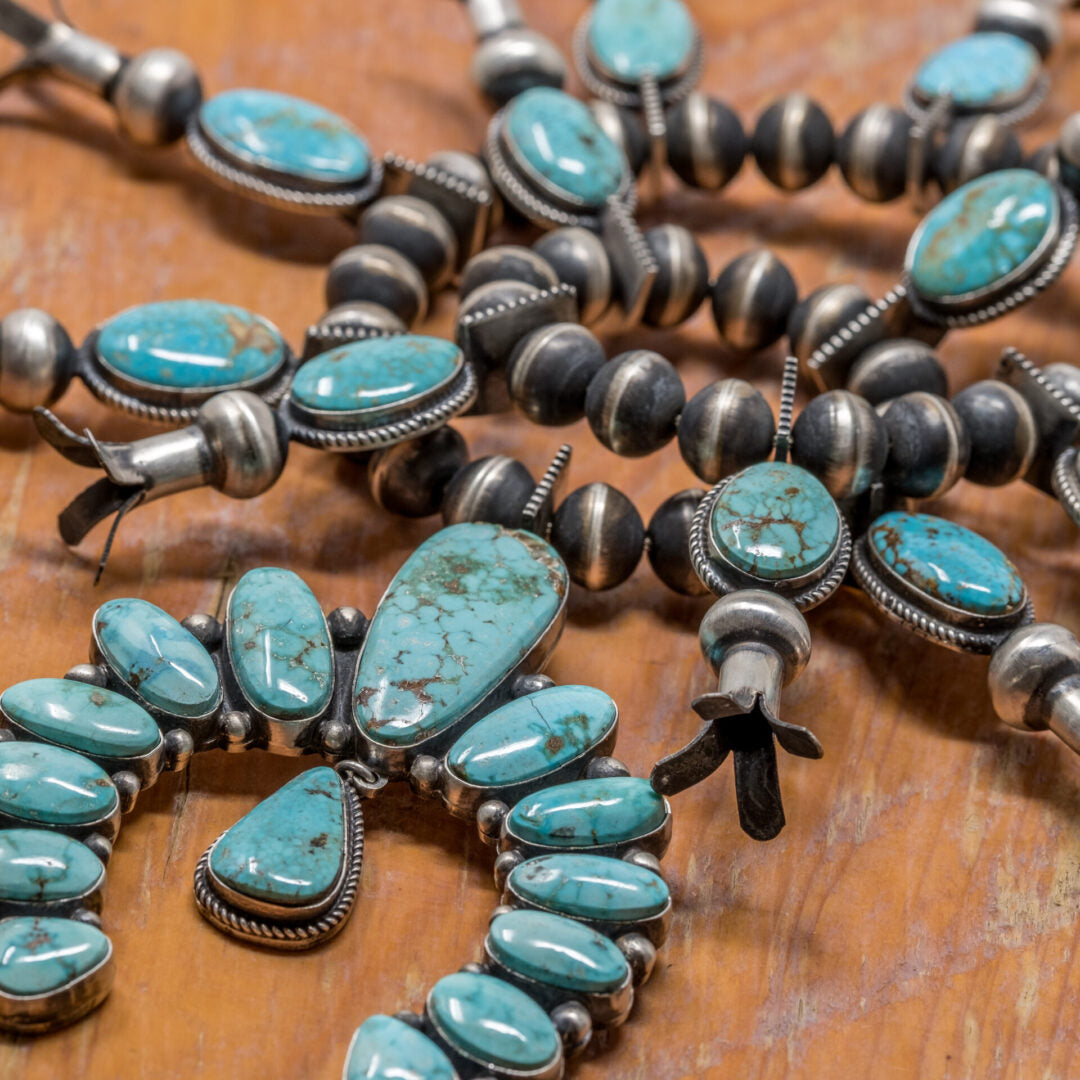 Naja pendant with turquoise shown on a strand of Navajo Pearls