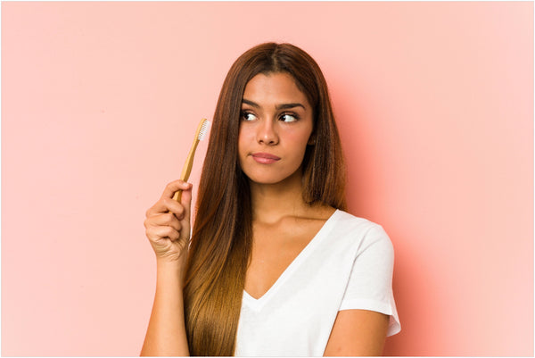 woman holding a toothbrush