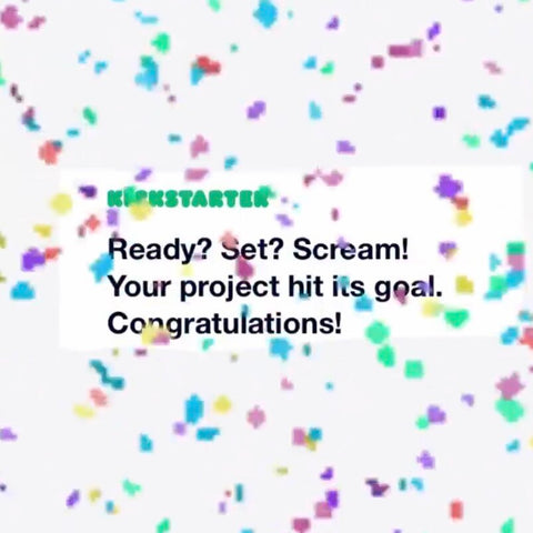 A white square with the words "Ready? Get Set? Scream! Your project hit its goal. Congratulations!" The words and square are covered in flecks of multicoloured confetti.
