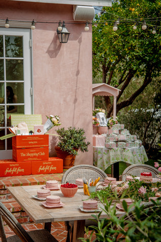 garden party including cake decorating, stacked boxes and flowers