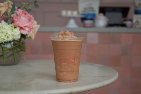 keto frozen hot chocolate in plastic up on table with flowers