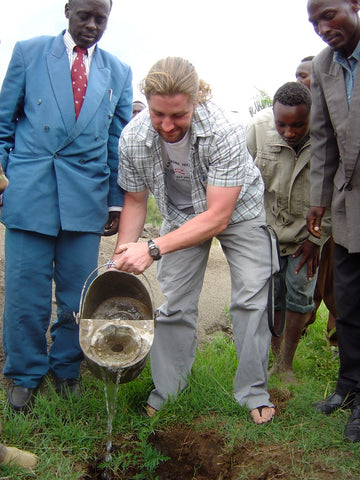 Mavuno Harvest founder Phil Hughes planting trees in Kenya