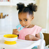 Young girl uses the Blue Koala Baby Toon™ Silicone Teether Spoon.