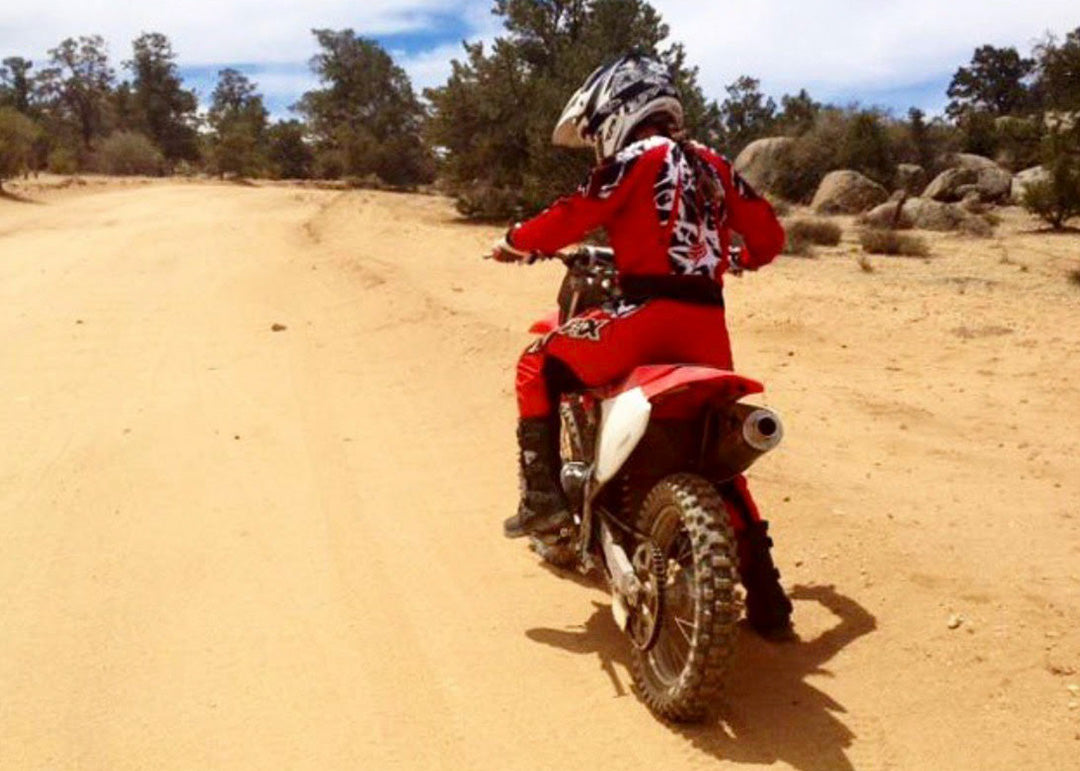 Women riding dirt bikes in the desert