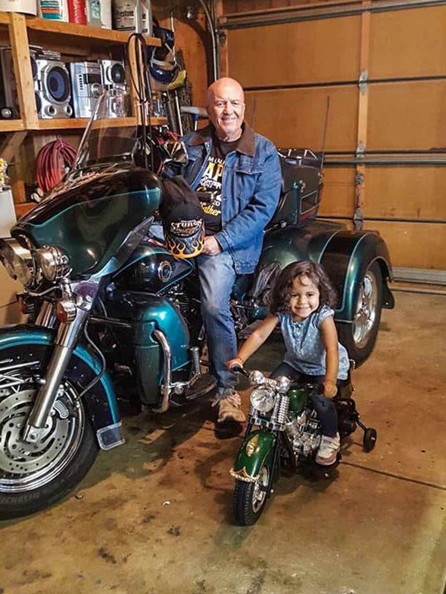 Grandfather and granddaughter sharing the love of motorcycles
